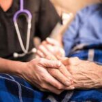 Nurse_holding_hands_with_patient