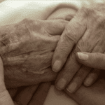 Holding The Hands Of A Dying Person