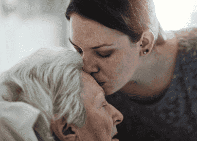 Daughter Kissing Her Dying Mothers Forehead