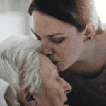 Daughter Kissing Her Dying Mothers Forehead