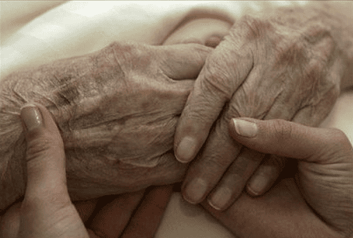 Holding The Hands Of A Dying Person