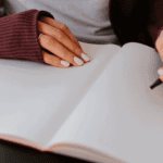 Person Writing In A Journal