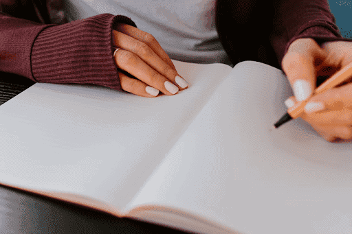 Person Writing In A Journal