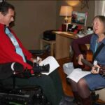 Music therapist Becky Pansch of Fairview Hospice in Minneapolis and client Kevin Pollari in his living room. Credit – Marie Gentile, Fairview Health Services